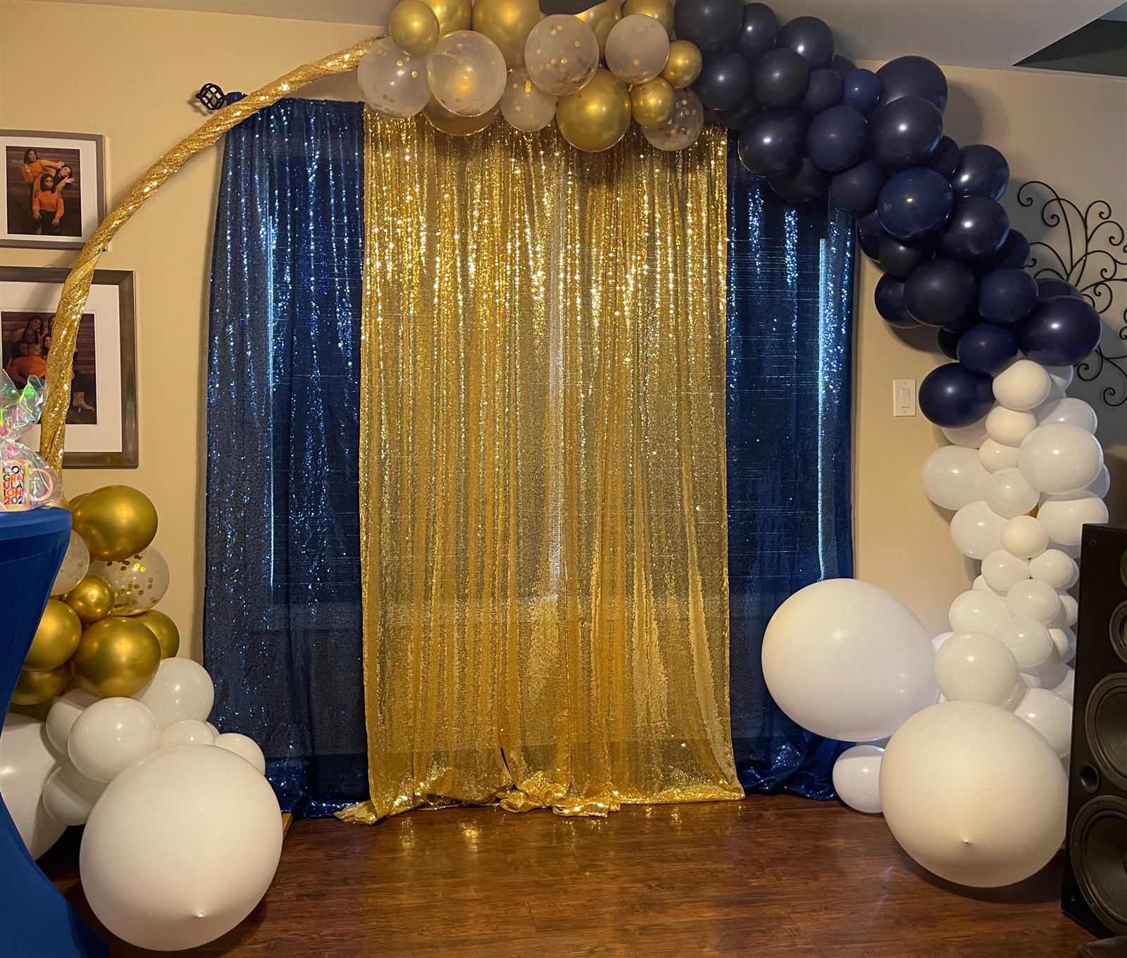 Navy and gold sequin curtain backdrop with balloon garland