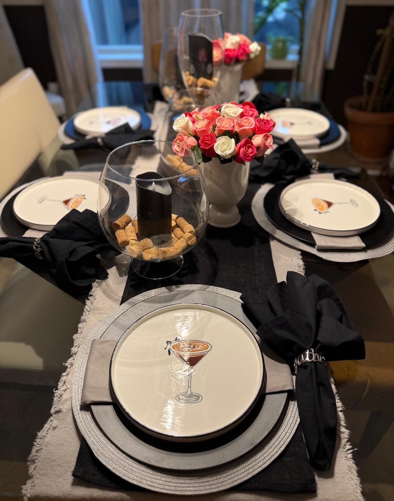 Black and white cocktail party table with martini glass plates and pink roses