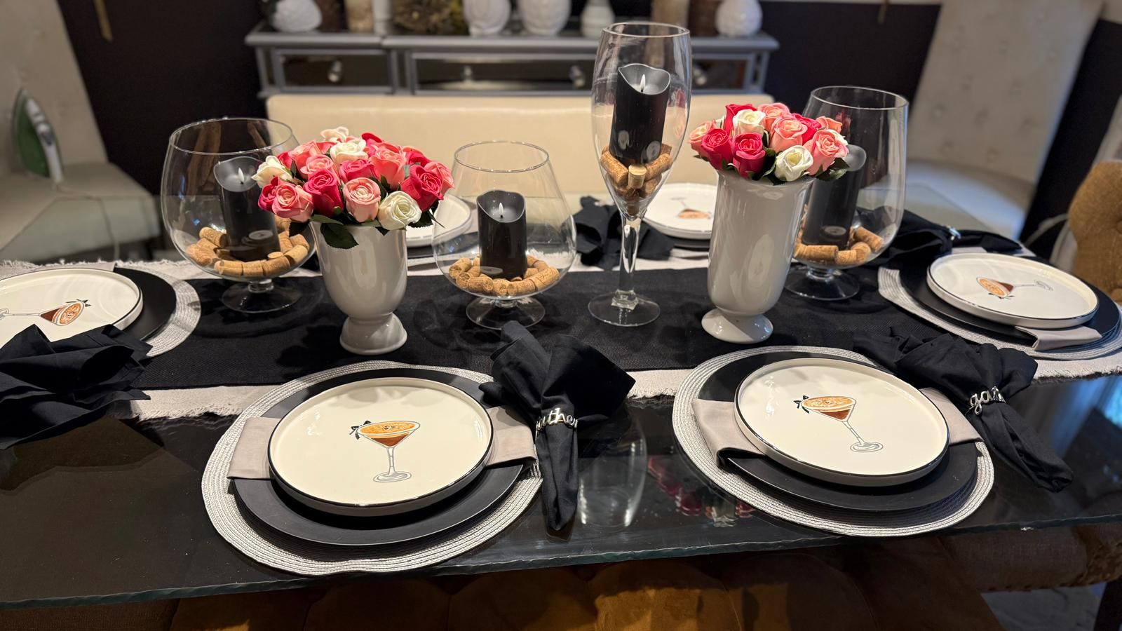 Detail of cocktail party table setting with roses and candlelight