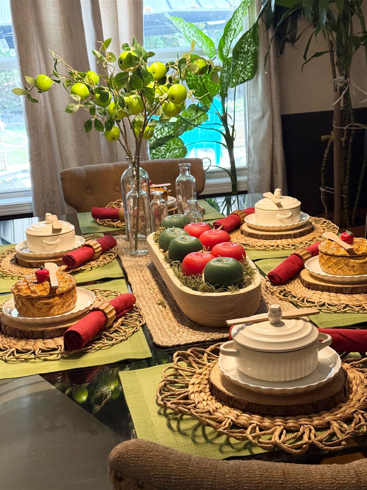 Rustic harvest dining table with apple candles and wood slice chargers