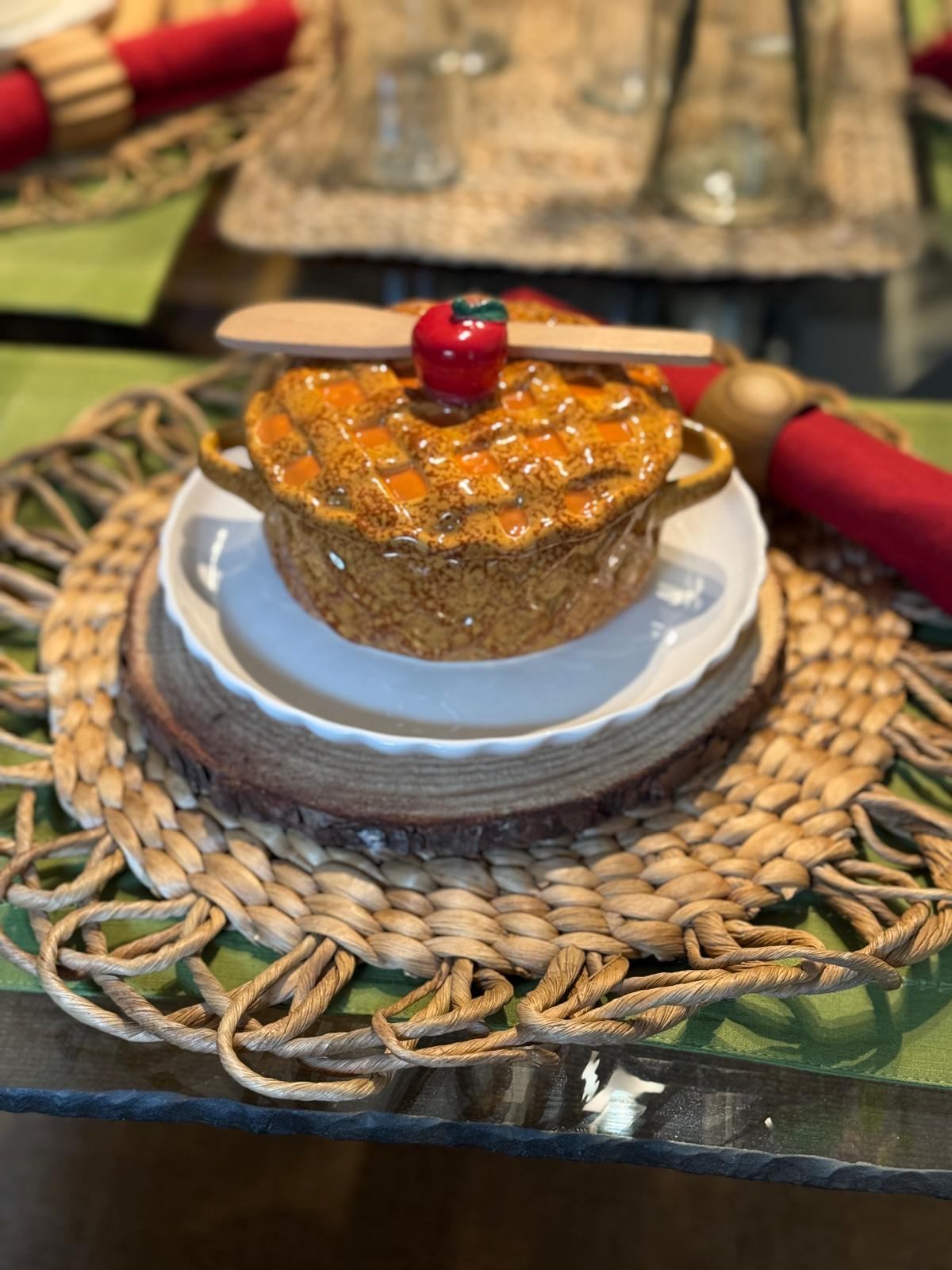 Individual apple pie dessert with a ceramic apple topper