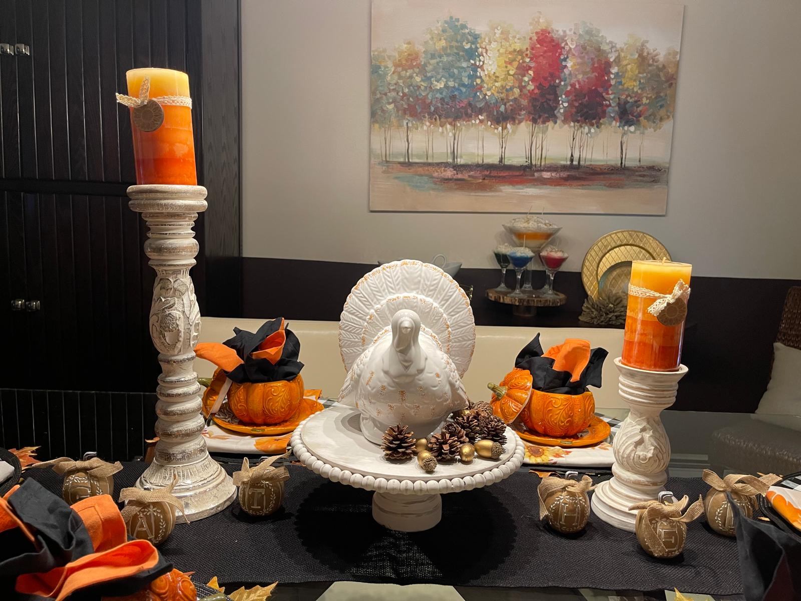 Thanksgiving mantel with a ceramic turkey, pinecones, and monogrammed pumpkin ornaments