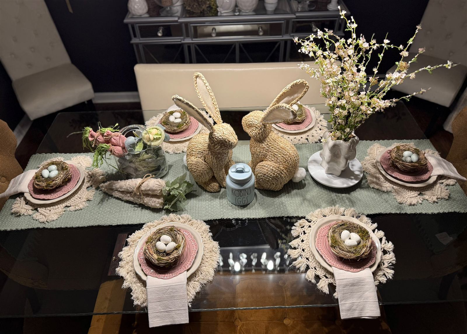 Spring table setting with woven bunnies, robin's egg jar, and cherry blossoms