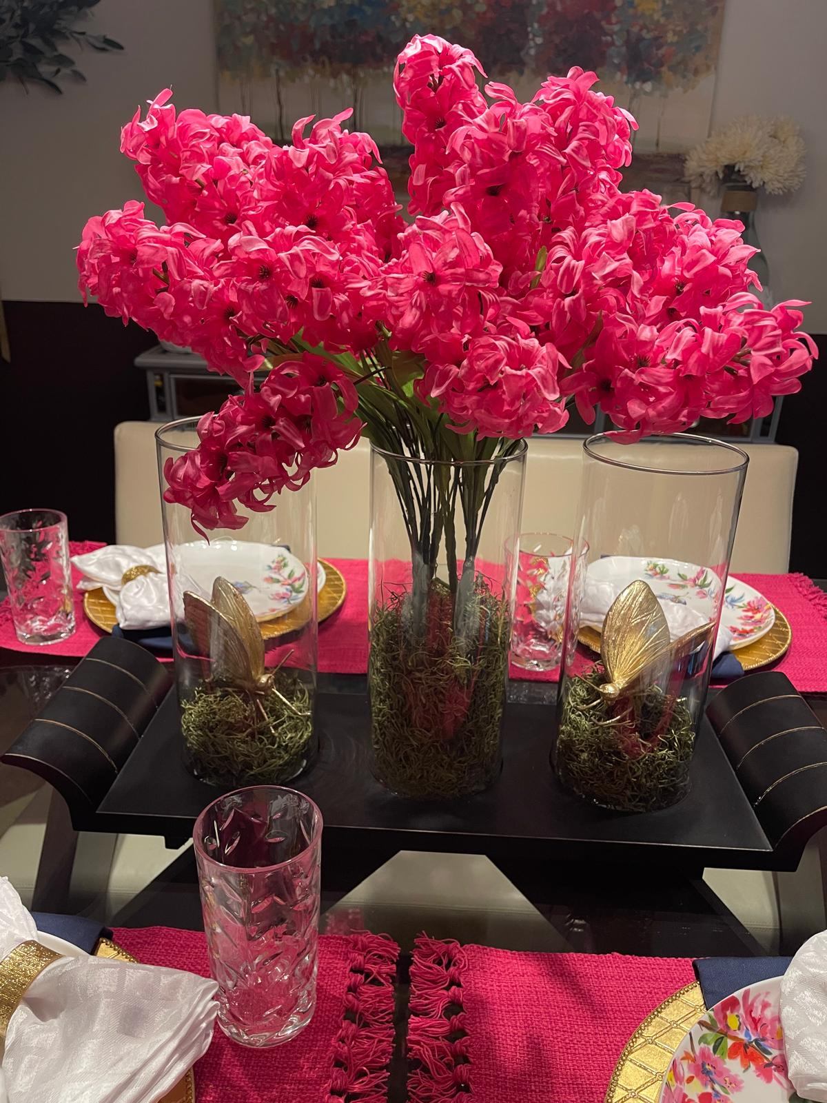 Centerpiece with pink hyacinth flowers and gold butterfly accents