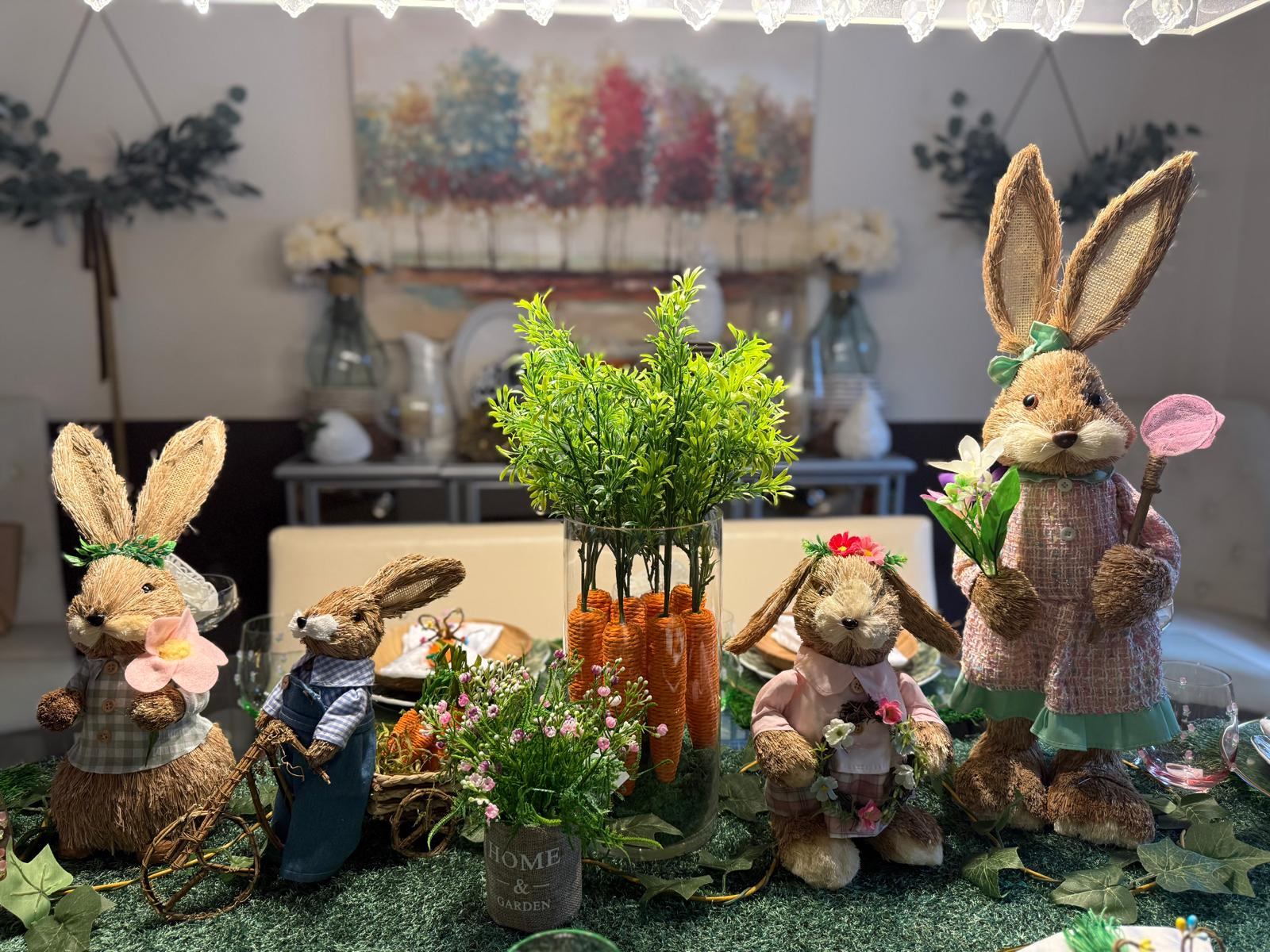 Group of bristle bunny figurines with a bicycle cart and carrot bouquet