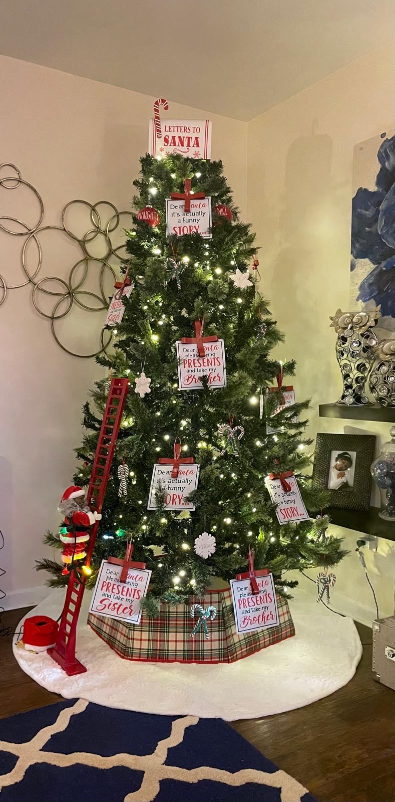 Christmas tree decorated with playful 'Dear Santa' ornaments and a toy ladder